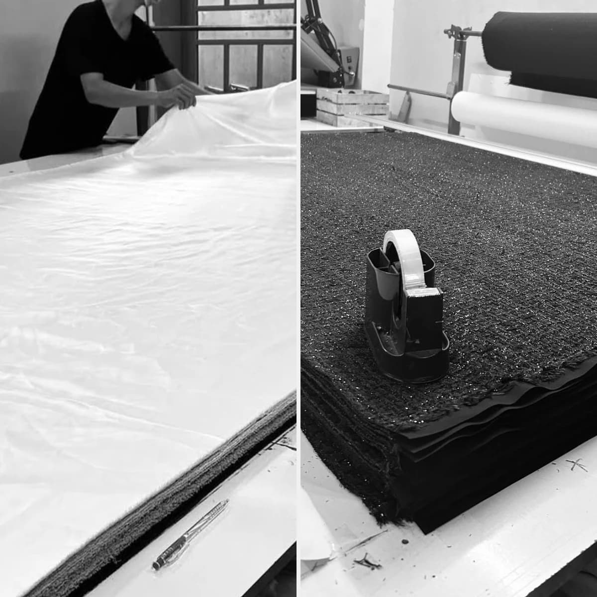 White fabric being spread and black textured fabric prepared in workshop lays